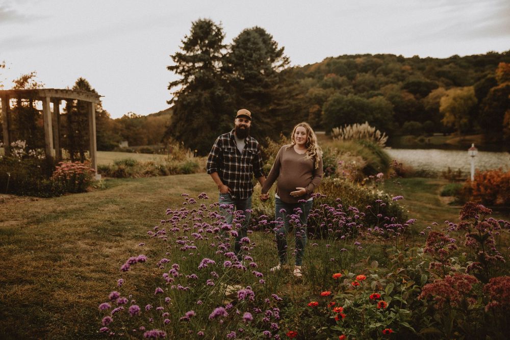 Couple shares intimate autumn maternity photo shoot in field with golden wildflowers at sunset. indiana pa photographer blue spruce park