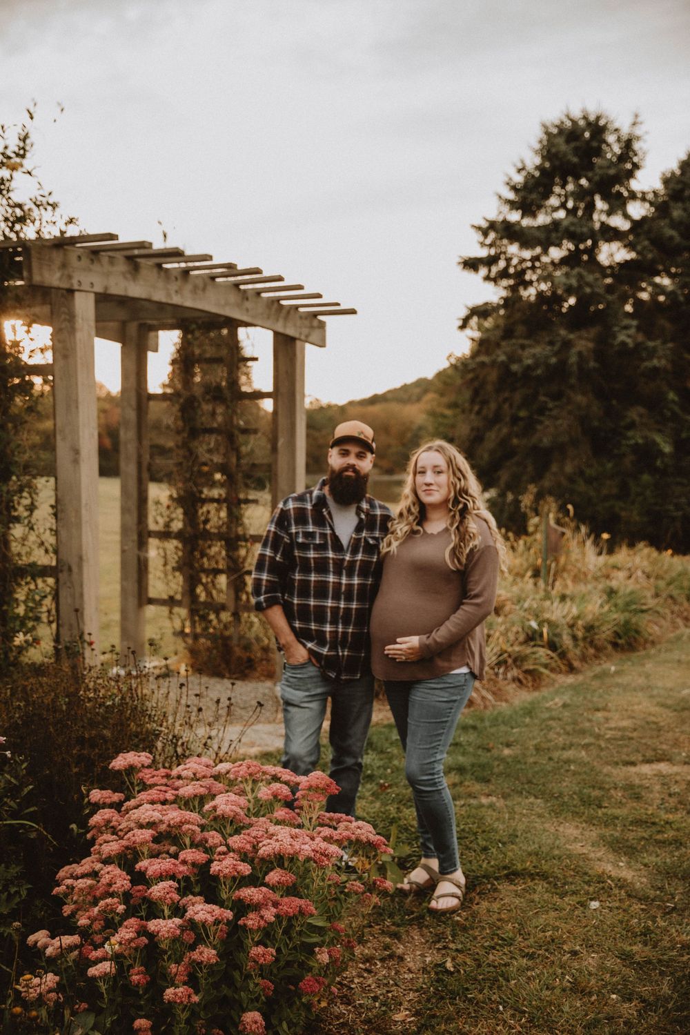 Couple shares intimate autumn maternity photo shoot in field with golden wildflowers at sunset. indiana pa photographer blue spruce park