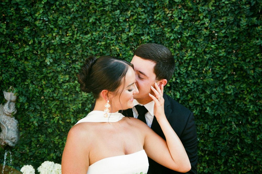 A series of intimate wedding photos showing couples sharing romantic moments in front of a lush green hedge.