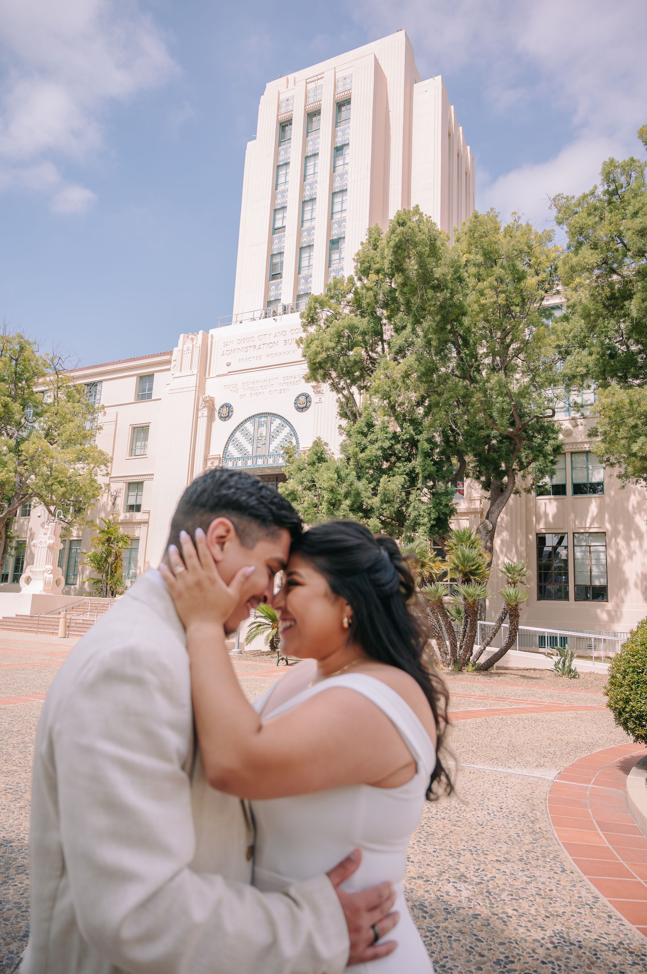 Elopement at the San Diego County Clerks office, couple standing in front of building looking at each other in love.