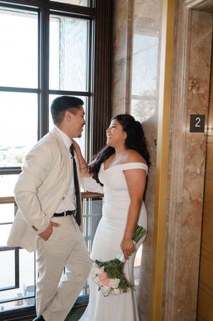 Elopement at the San Diego County Clerks office, couple leaning on wall next to elevator inside the clerks office after civil ceremony