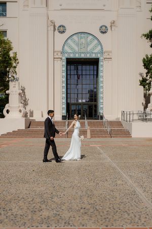 Elopement at the San Diego County Clerks office, couple walking across the front of the building holding hands