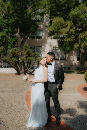 Elopement at the San Diego County Clerks office, couple standing in front of building in love
