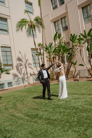 Elopement at the San Diego County Clerks office, couple dancing in the grass next to the building