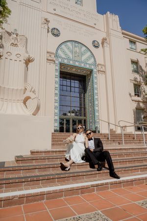 Elopement at the San Diego County Clerks office, couple sitting on steps with fun sunglasses on.