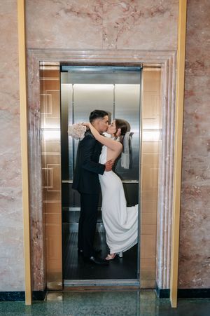 Elopement at county clerks office, couple kissing in elevator after their civil ceremony.
