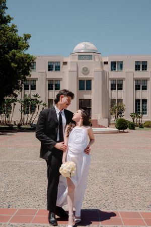 Elopement at the San Diego County Clerks office, couple standing in front of building looking at each other in love.
