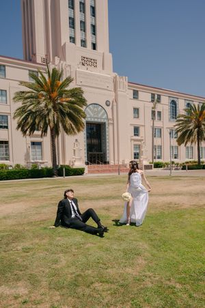 Elopement at the San Diego County Clerks office, man admiring new wife as she spins with her dress and bouquet