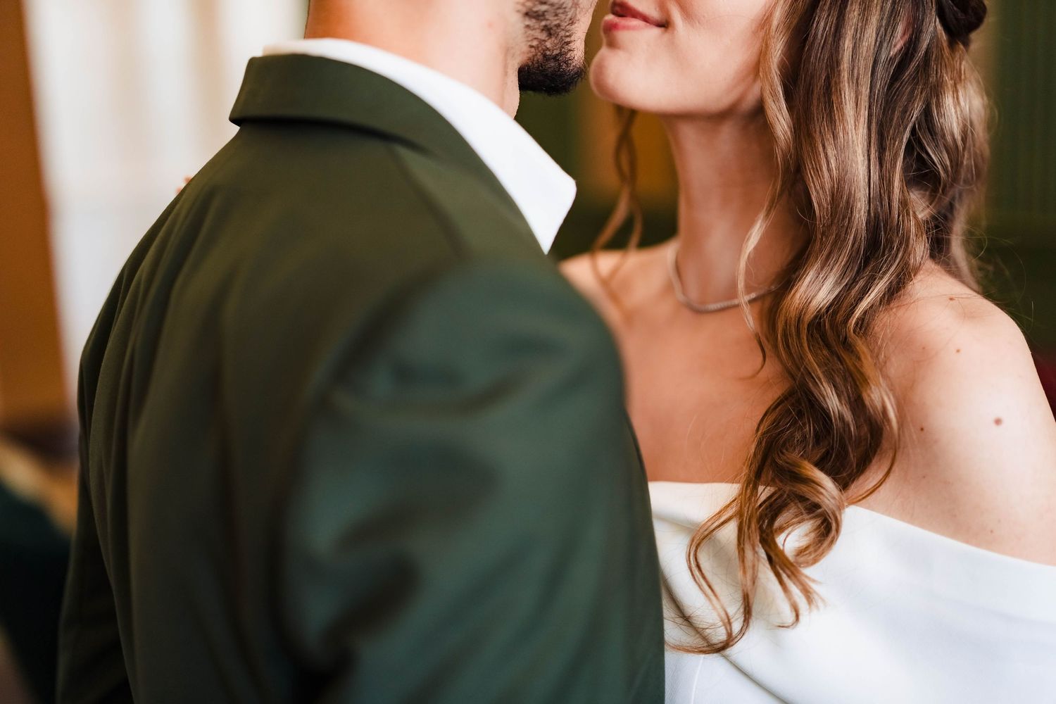 Romantic close-up shot of couple in formal wedding attire.