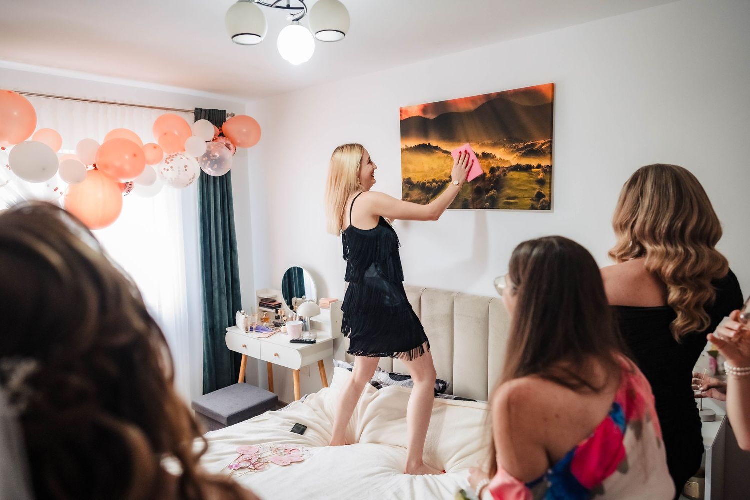 Wedding preparation scene in bright room with balloons and decorations.