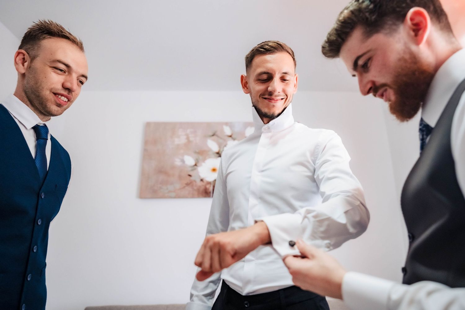 Groomsmen in formal suits gather for preparation before the wedding ceremony.