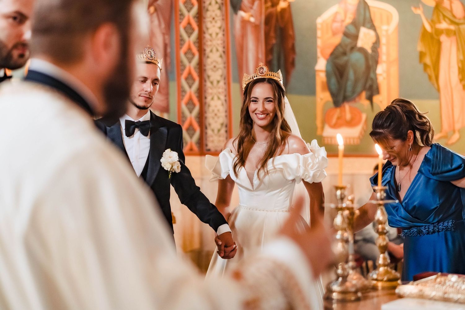 Elegant wedding ceremony taking place in a beautifully decorated church with ornate details.