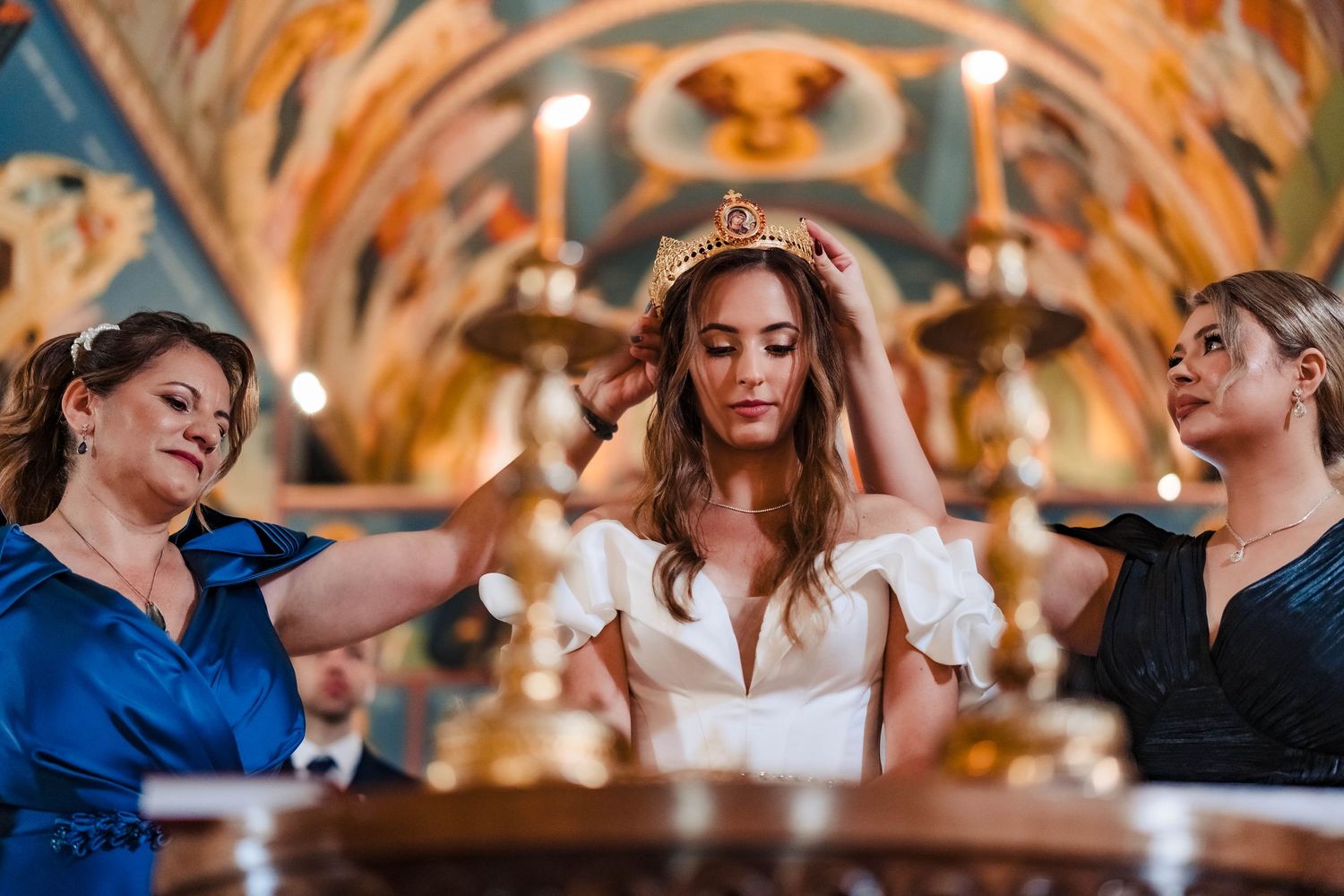 Wedding celebration in an ornately decorated church with painted ceiling and golden details.