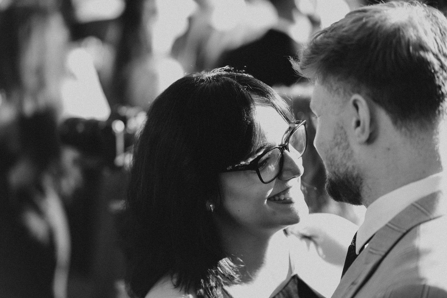 Black and white candid moments captured during an intimate wedding celebration.