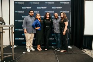 A group of people pose together against a black backdrop with Soundexchange branding at a promotional event.