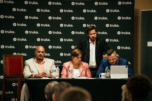 Panel discussion with five people seated at a long table with microphones and Trulia branding visible in background.