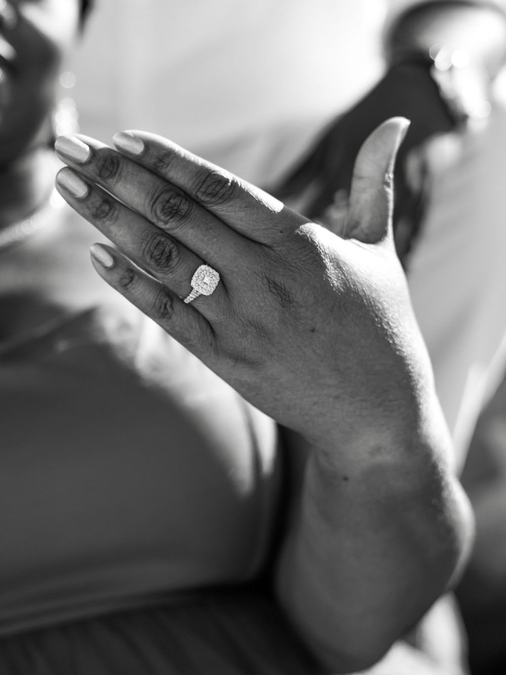 A series of black and white artistic photographs showing a hand with a ring in different angles and perspectives.