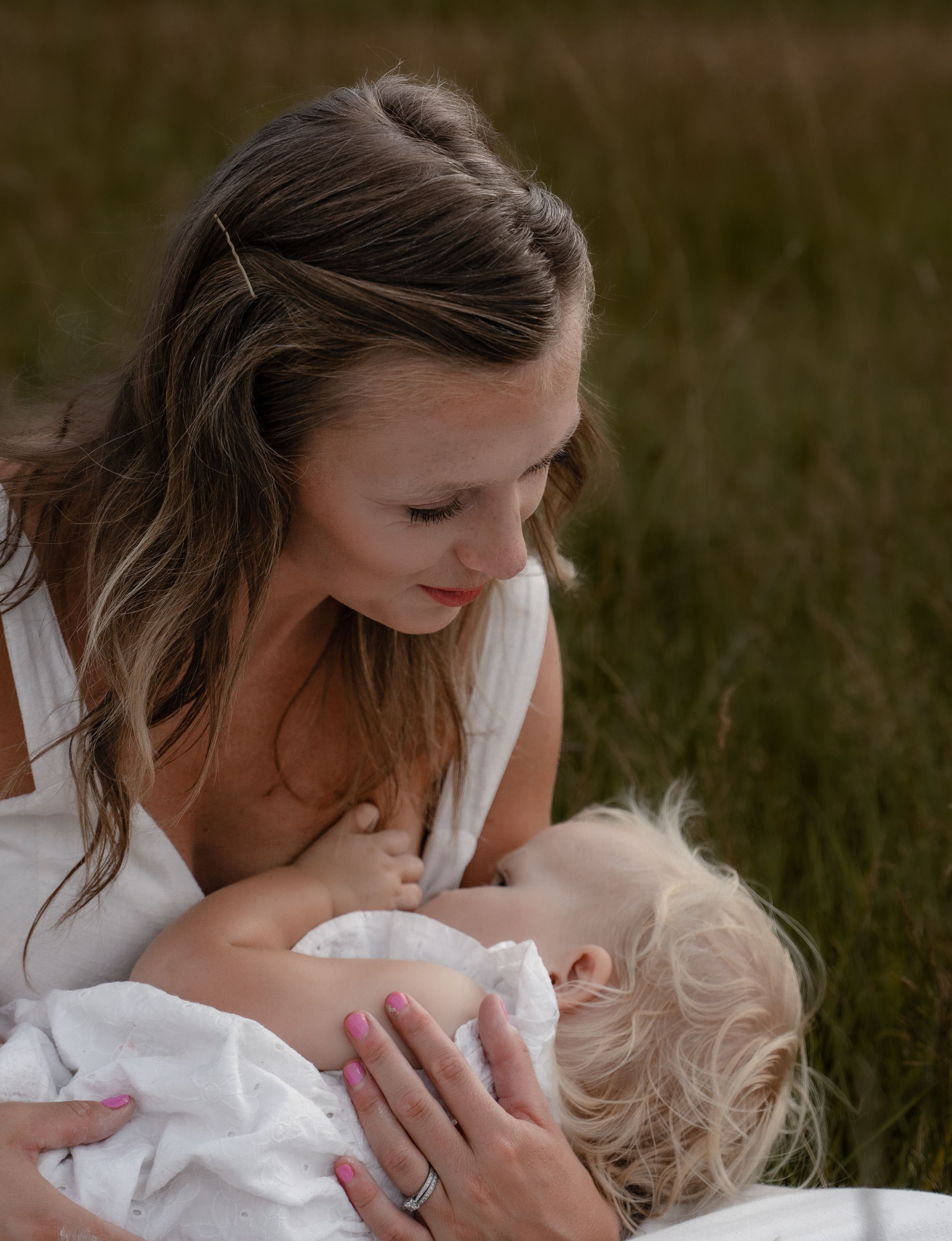 Mother and baby share tender bonding moments in a series of intimate outdoor portraits at golden hour.