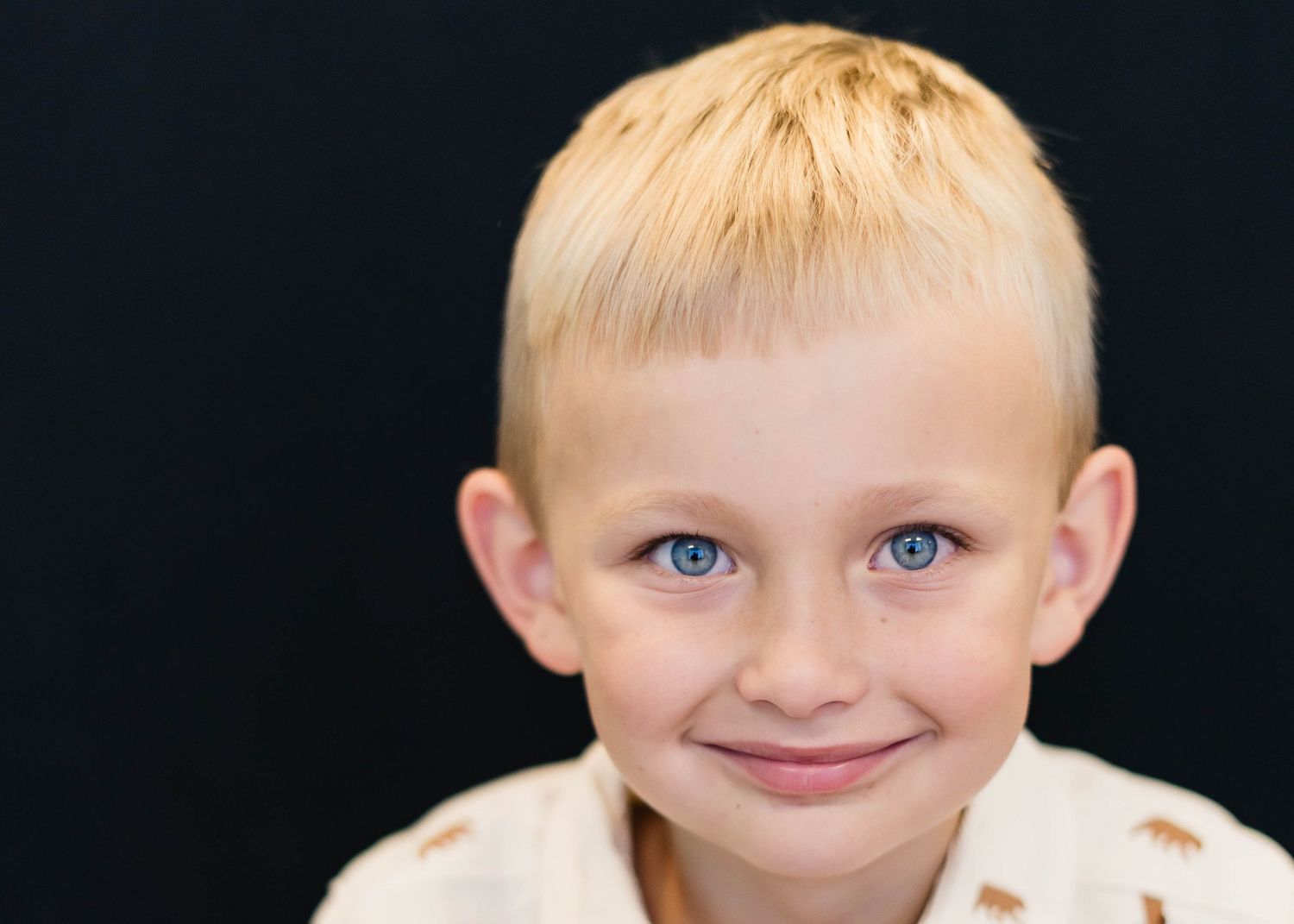 Boy with a thoughtful look during sensory-friendly school portraits in Brevard County.