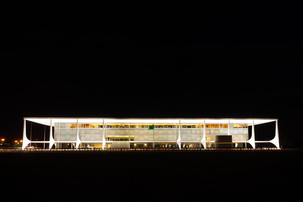 Night view of modern illuminated government building Palacio do Planalto in Brasilia with its distinctive white architecture.