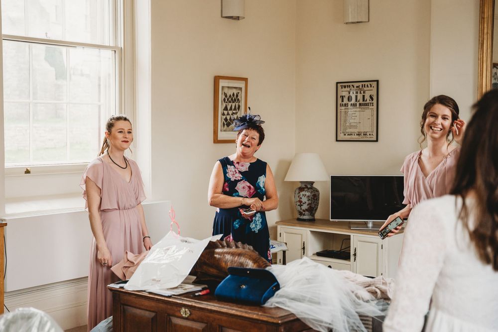 Candid moments during wedding preparations in a bright indoor space.