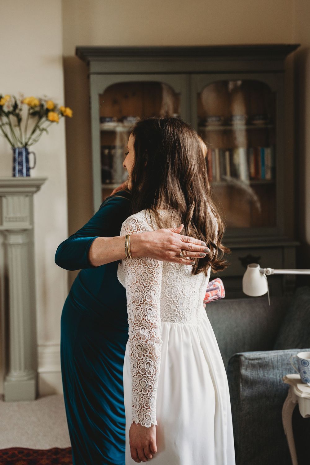 Wedding dress fitting and final adjustments in an elegant indoor setting.