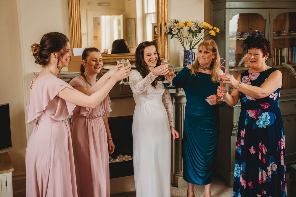 Wedding party members celebrating together in formal attire.