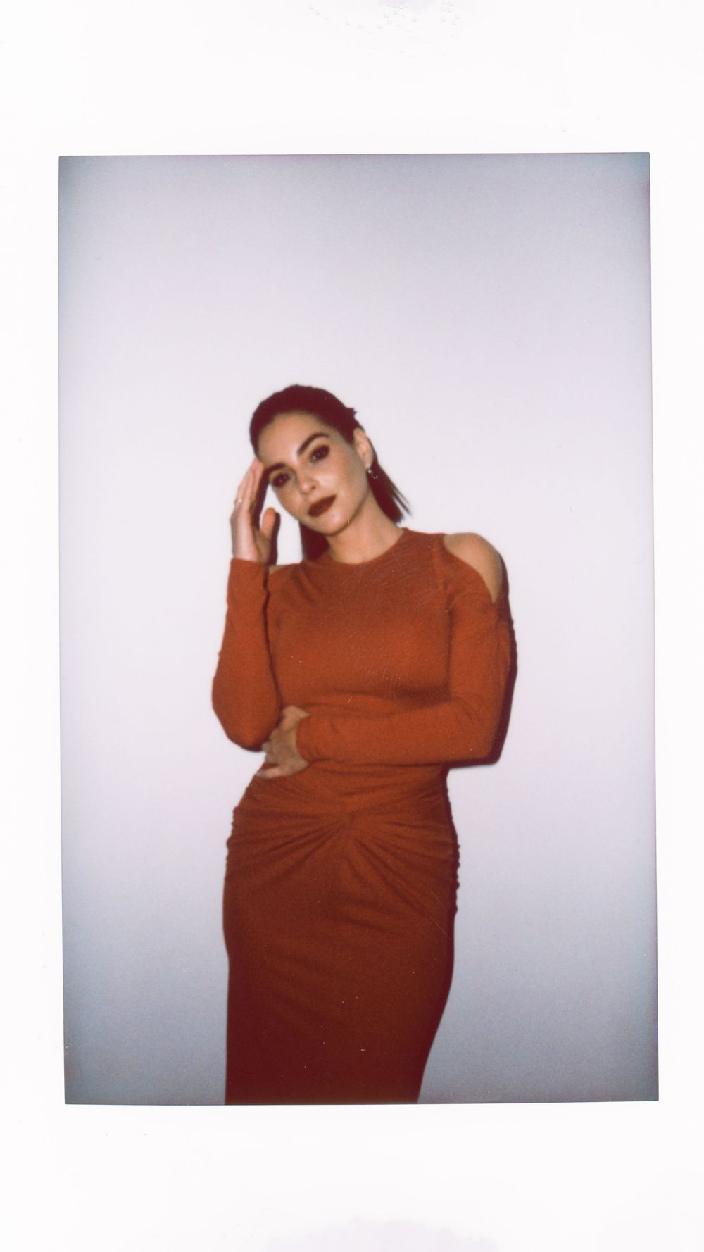A series of artistic portrait photographs showing a person in a rust-colored sweater posing against a light background.