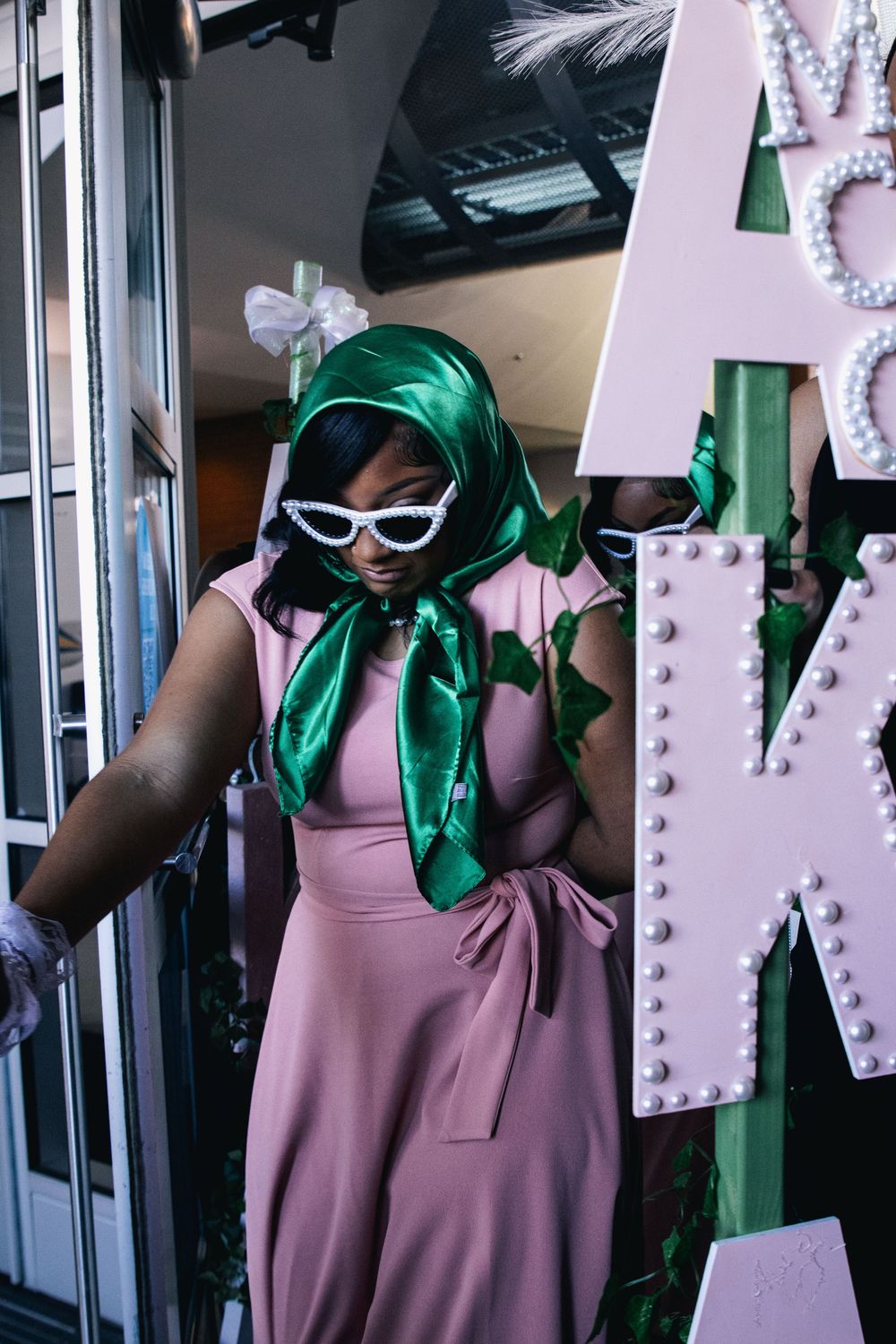 Multiple poses of model in vintage-inspired outfit with white sunglasses and green silk scarf.
