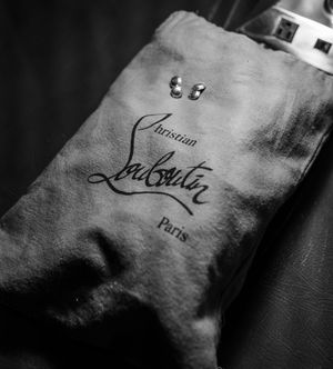Black and white close-up shots of Christian Louboutin signature branding on leather products.