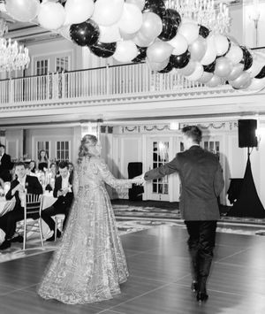 Black and white reception hall decorated with white and black balloons.