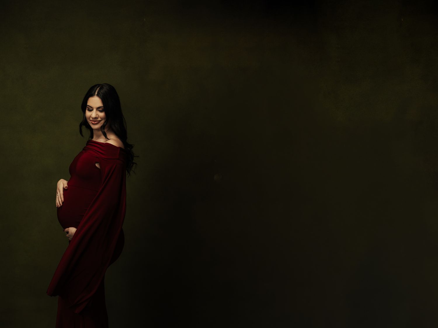 Romantic couple portraits in dark moody studio setting.