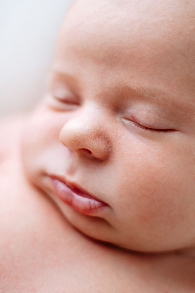 A peaceful close-up view of a sleeping baby's face showing their delicate features and serene expression.