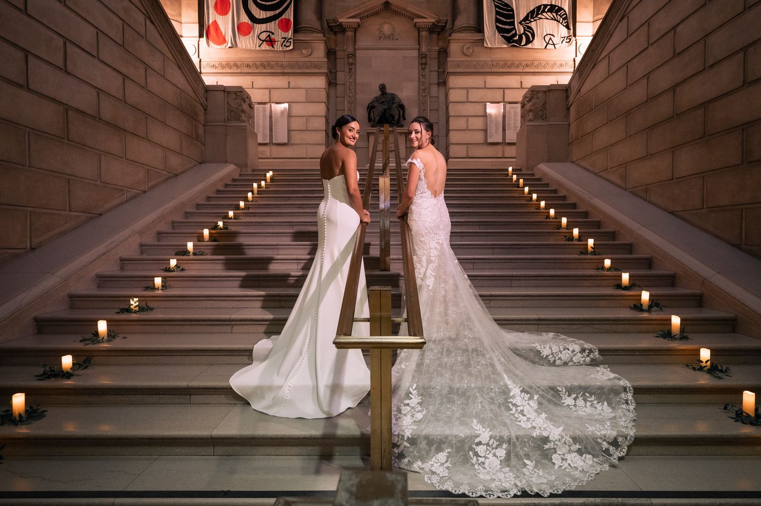 A romantic wedding couple stands on grand stone steps in the Free Library of Philadelphia.