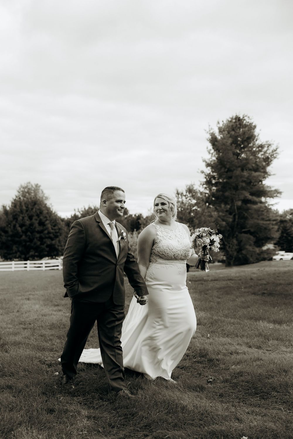Black and white wedding portraits captured on a rolling hillside.
