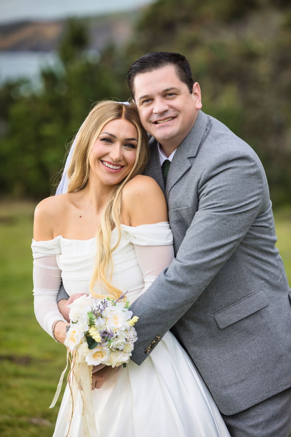 A couple in wedding attire share joyful embraces outdoors in a series of candid moments against a natural backdrop.