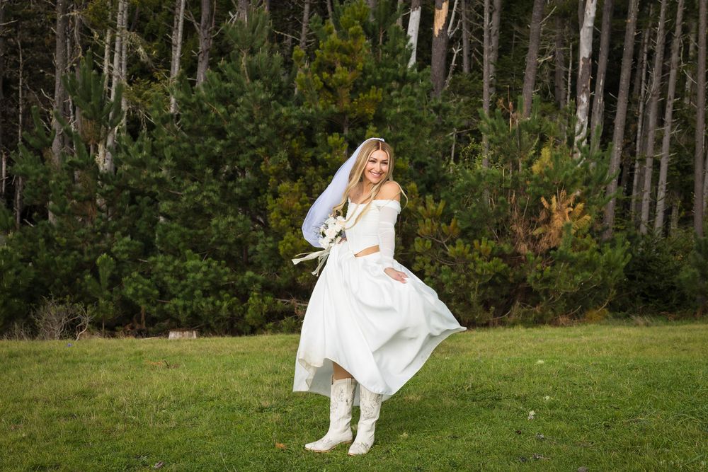 A bride in a flowing white dress walks through a lush forest setting in a series of candid poses.