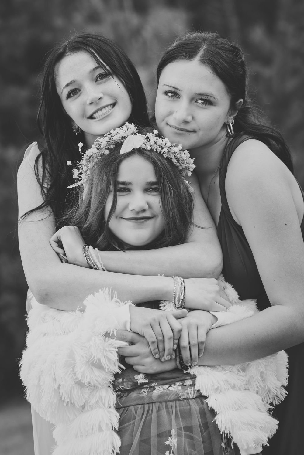 Black and white photo series showing close embraces between two people wearing contrasting white and dark attire.