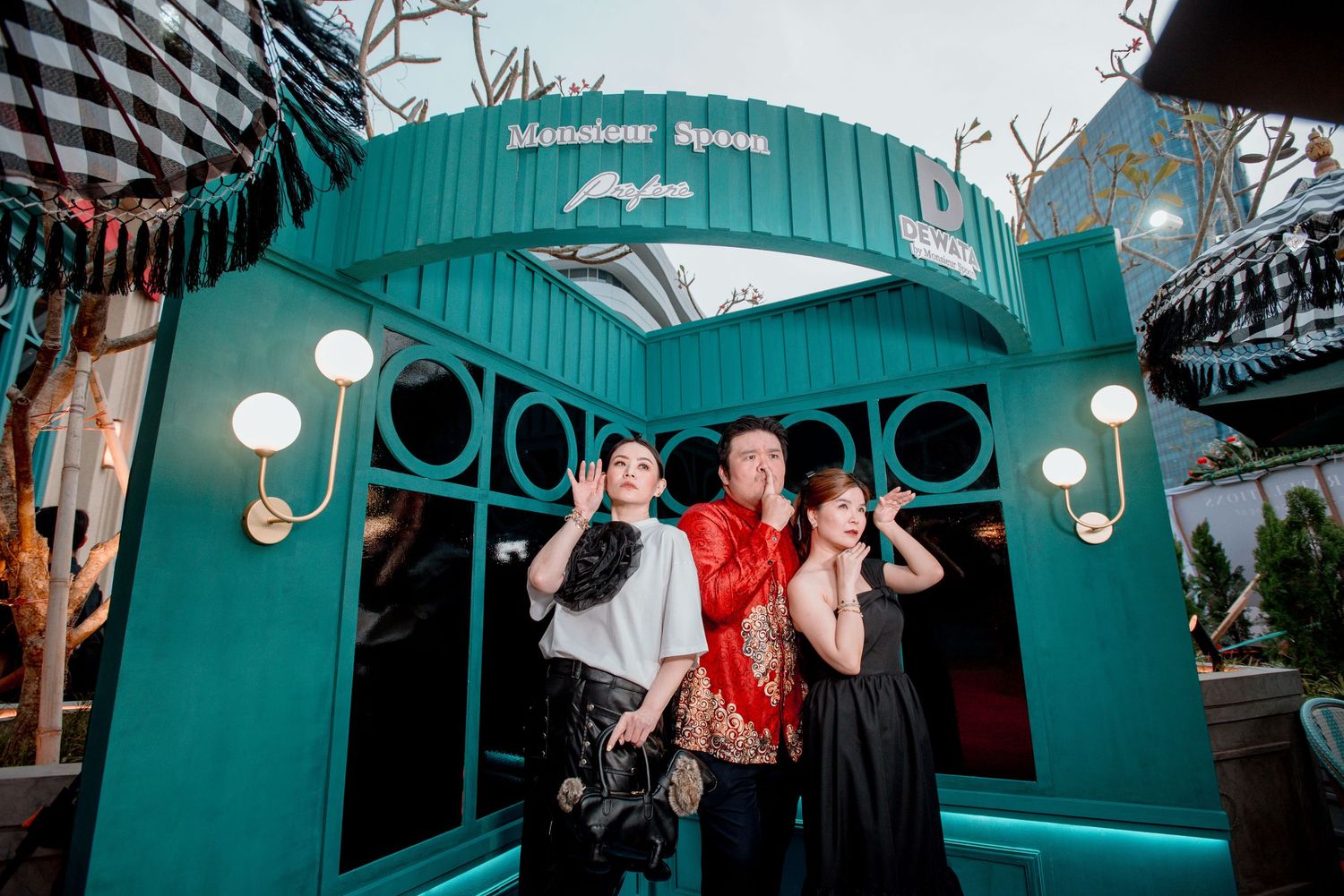 A series of photos showing a festive holiday gathering with teal-colored decor and lighting elements.