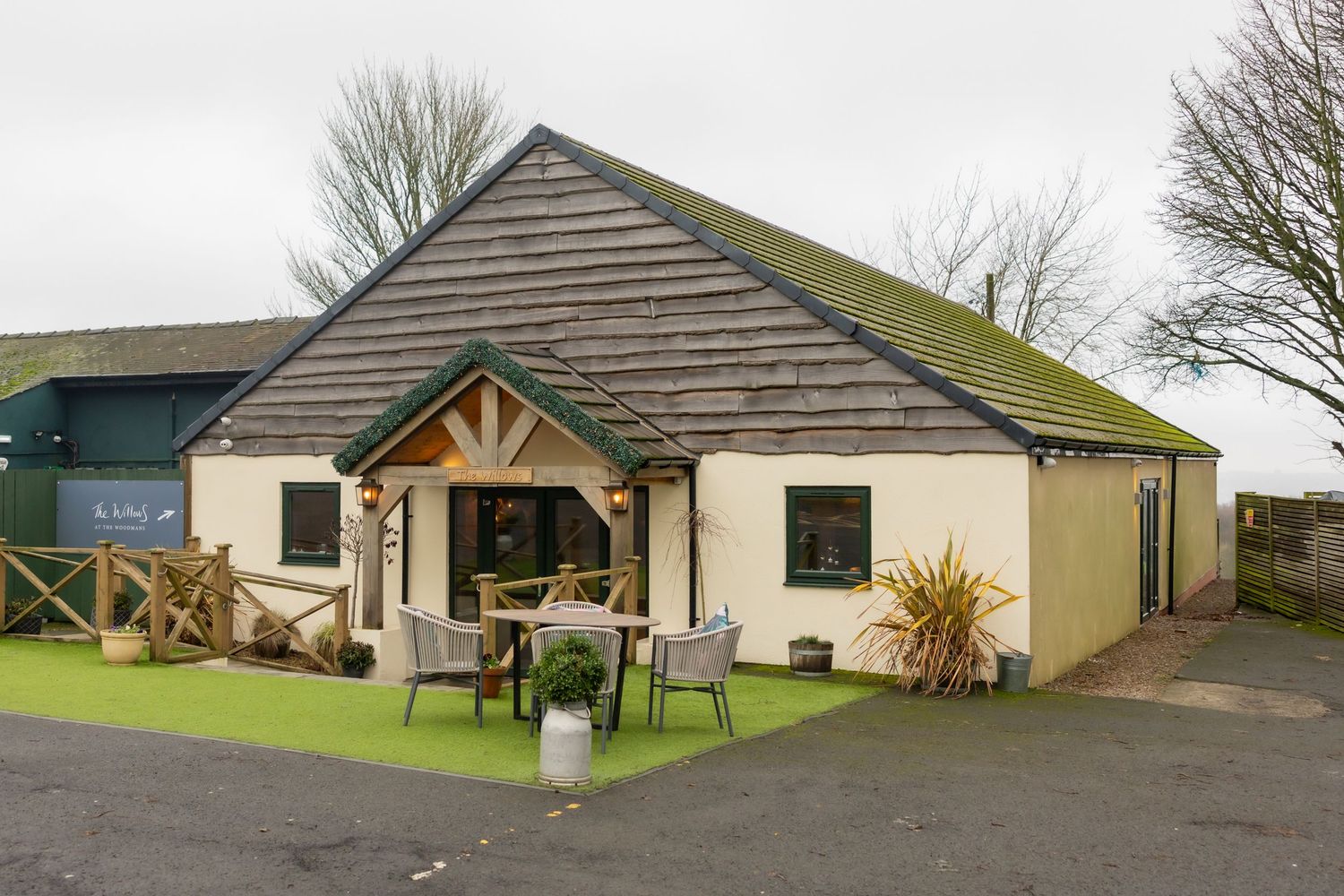 Exterior view of modern bungalow vacation rentals with green landscaping and parking areas in rural setting.