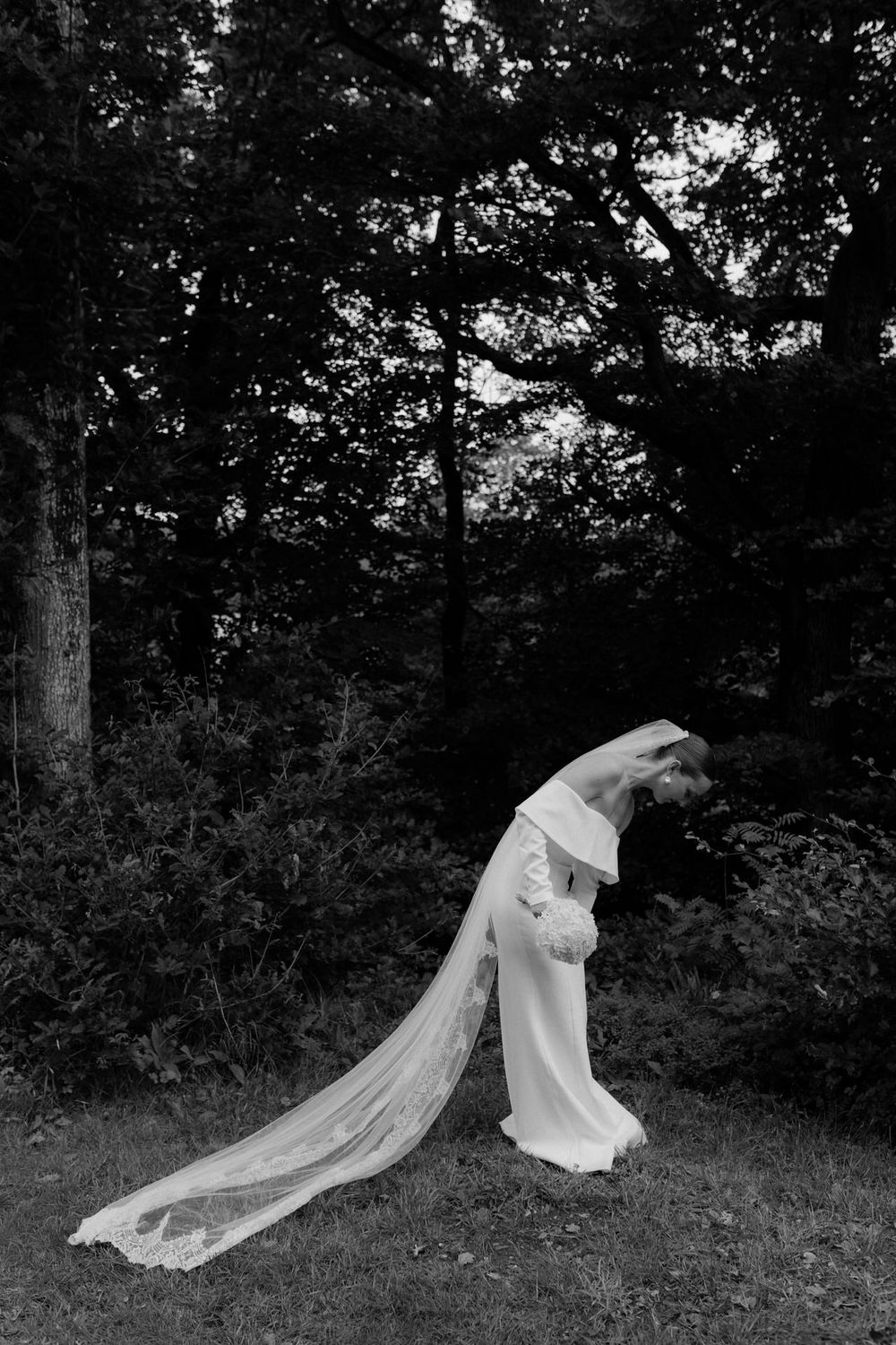 A flowing white wedding dress and veil float gracefully through a dark wooded setting in a series of artistic photographs.