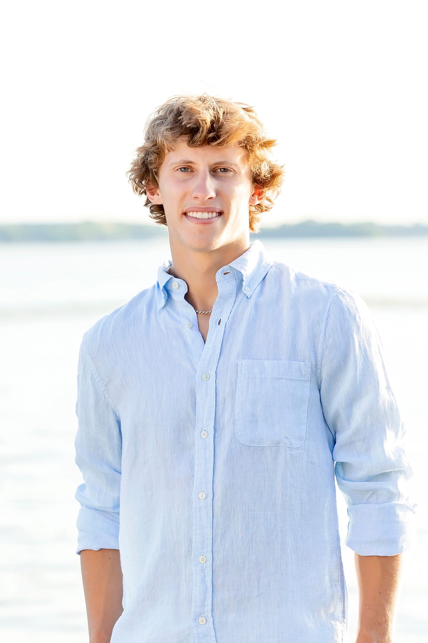 Senior boy portrait with lake background during Clear Lake Iowa senior photo session at the Fox House.