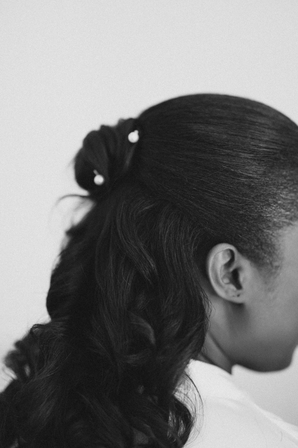 Artistic black and white profile shots showing elegant hairstyling details.