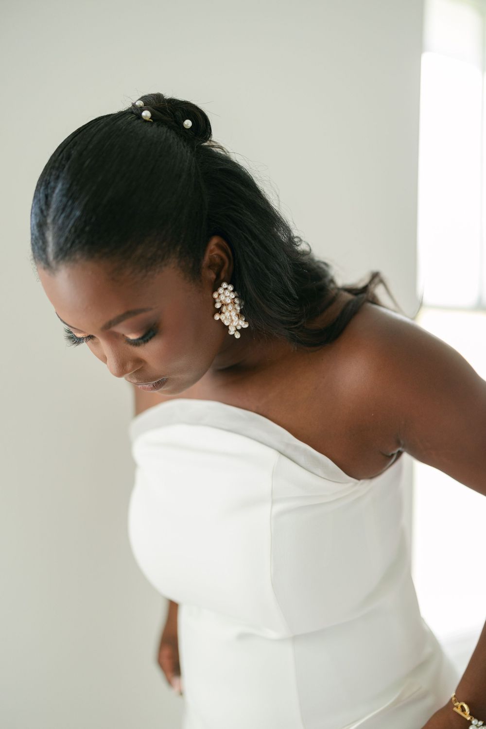 Elegant white strapless wedding dress detail shown in multiple angles against a light background.