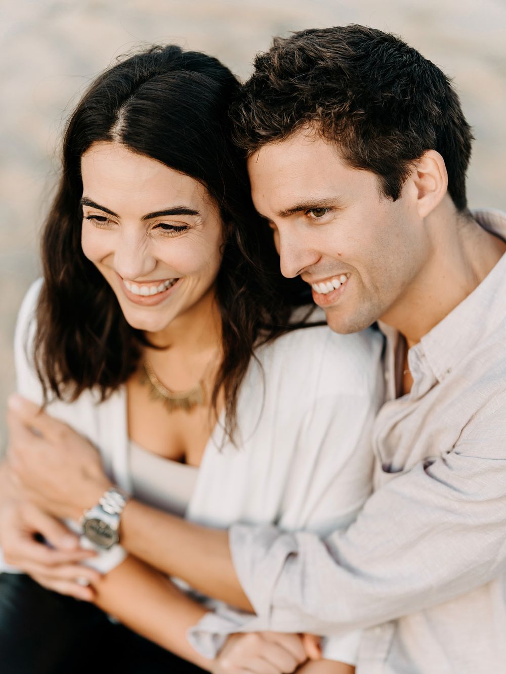 A couple shares intimate moments while looking at their phones together in a series of candid shots.