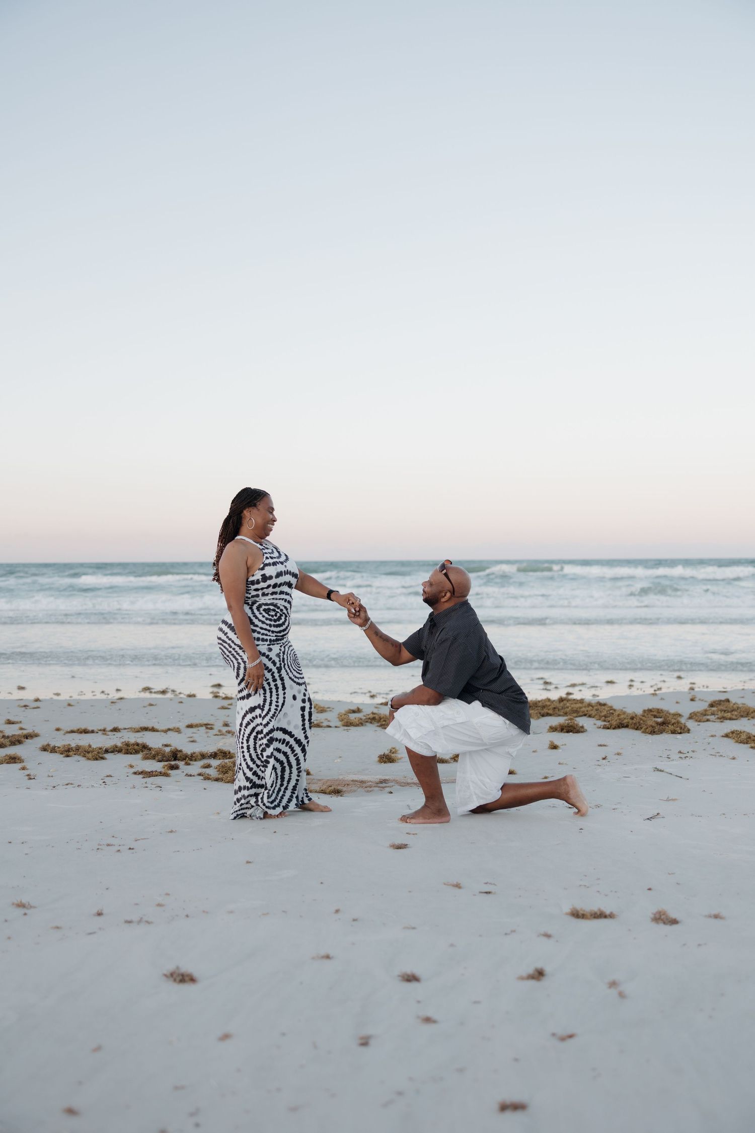Blurred motion portrait of couple in sunglasses outdoors.