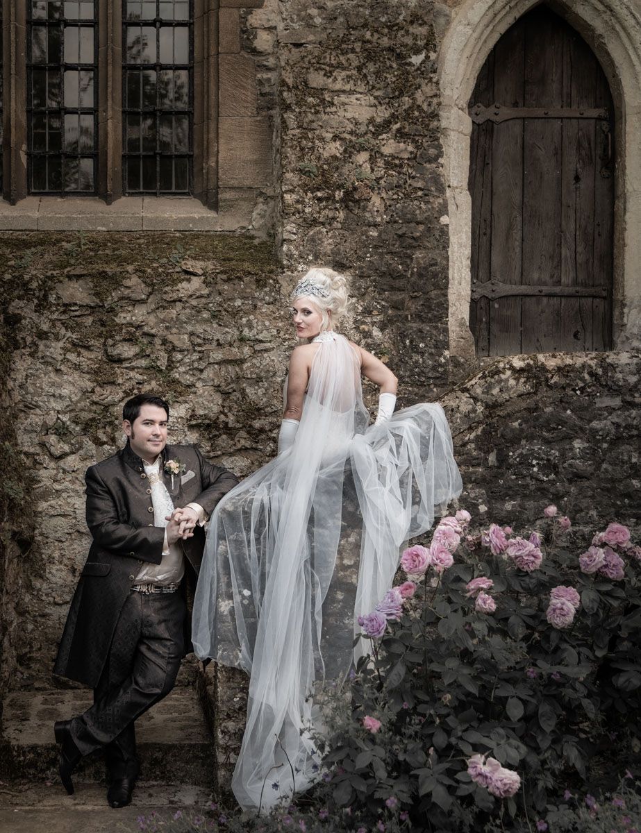 Editorial wedding portrait set against the façade of a historic Kent castle