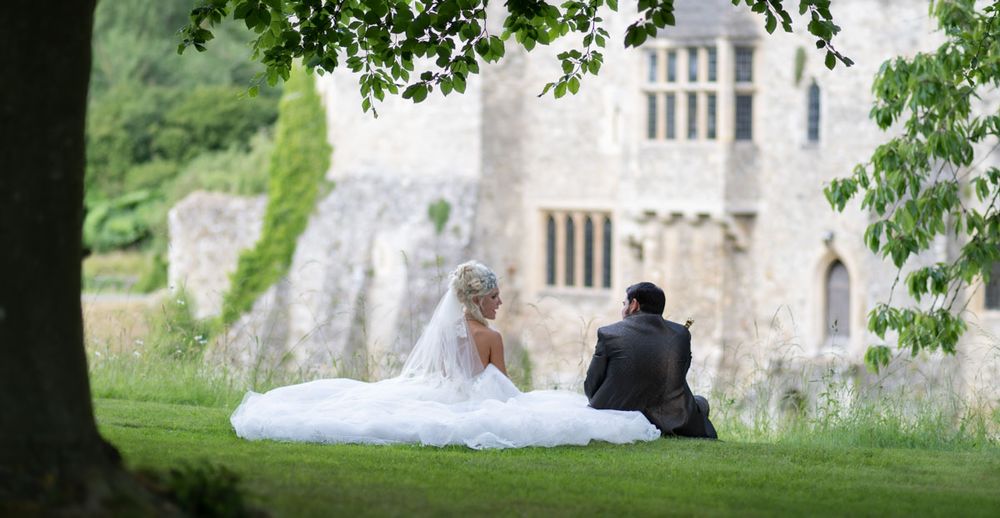 Bride and groom with medieval castle in background | Allington Castle, Kent