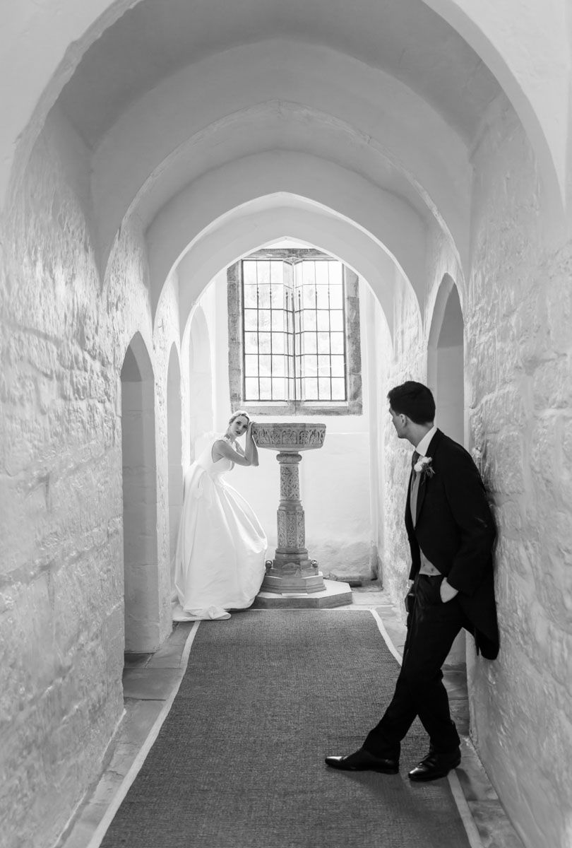 Bride and groom in medieval priory archway