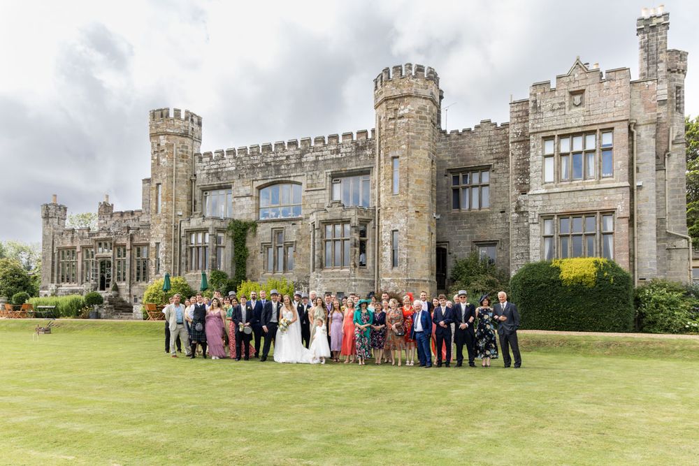 Wedding party group shot in front of Wadhurst castle, East Sussex